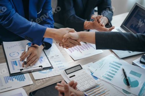 Preview: business team meeting, success is celebrated with handshake. Hands close up, dressed in formal suit