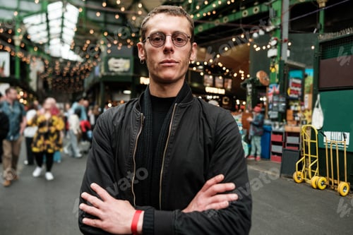 Preview: Security guard standing with crossed arms in borough market, london