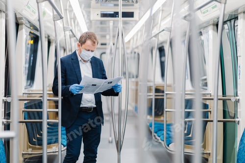 Vista previa: male entrepreneur wears disposable medical mask and gloves in metro, prevents coronavirus disease