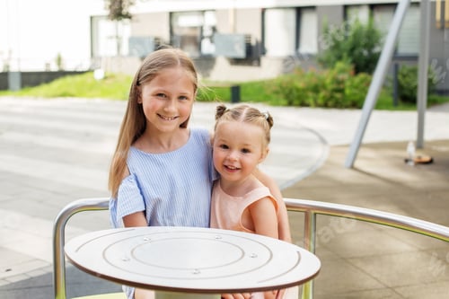 Preview: Two sisters ride on carousel and hug. Sensory experience. Having fun. Baby development