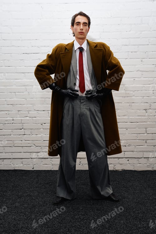 Preview: Stylish man poses confidently in a modern fashion display with artistic flair