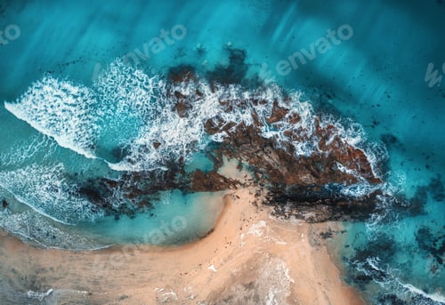 Preview: Aerial view of waves, rocks and transparent sea