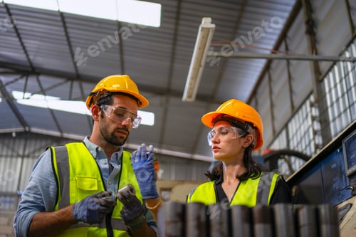 Preview: Blue collar workers are working at machine shop with CNC lathe machine.