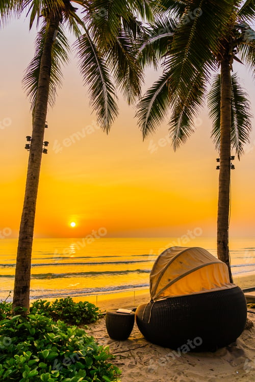 Preview: Umbrella and chair on the beautiful beach and sea at sunrise tim