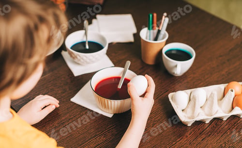 Preview: Father and son painting easter eggs, decoration. Home, family holiday. Kid, homemade creative