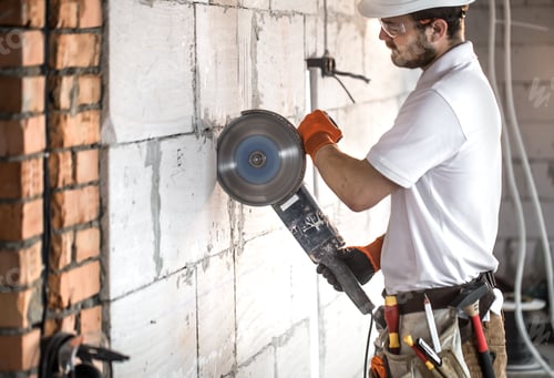 Preview: The industrial Builder works with a professional angle grinder to cut bricks.