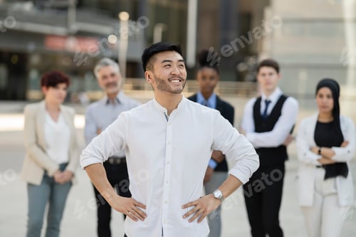 Preview: Asian businessman with his team behind him
