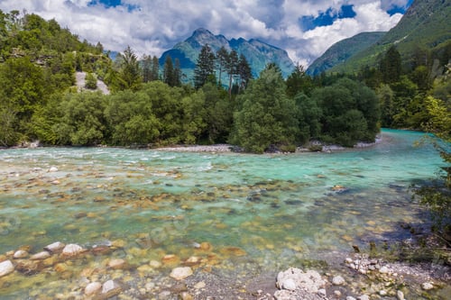 Preview: Crystal Clear Soca River Winding Through Lush Forest and Rocky Landscape of Slovenia