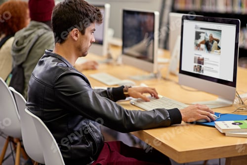 Preview: Gathering facts online. Shot of students working on computers in a university library.