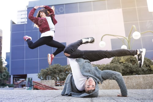 Preview: Young happy couple dancing on the street