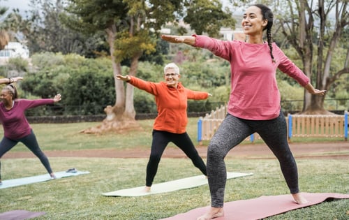 Preview: Multi generational people doing yoga class keeping at city park - Focus on right girl face