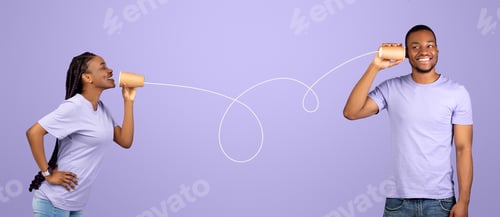 Preview: African American couple talking through tin can telephone