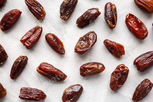 Preview: Pitted Organic Dates on gray background, top view. Flat lay, overhead, from above.