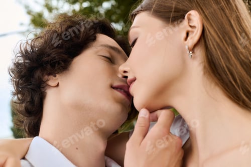 Preview: Young couple shares a tender moment outdoors surrounded by nature and joy