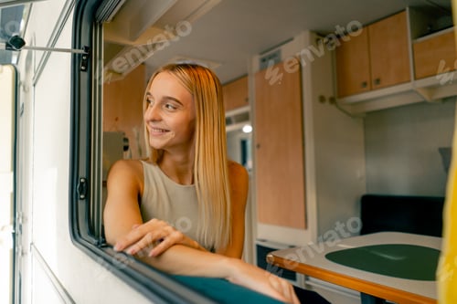 Preview: A beautiful girl rides in a trailer on a trip looks out the open window and smiles