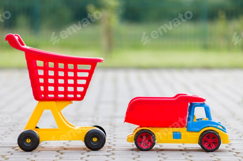 Preview: Bright plastic colorful toys for children outdoors on sunny summer day