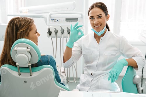 Preview: Smiling Dentist Gives Okay Sign to Patient