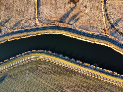 Preview: Drone shot of a river in a field