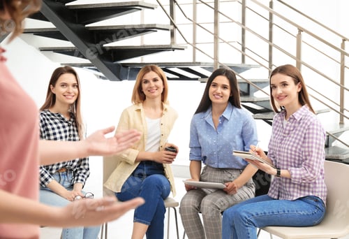 Preview: Female coach working with ladies in room. Women power concept