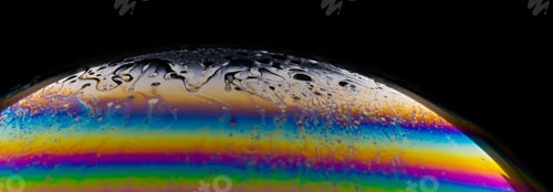Preview: Macro shot of a colorful soap bubble on a dark background