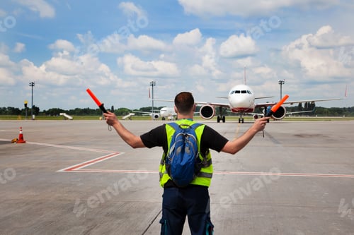 Preview: Air traffic controller at the airport. The man salutes and guides the plane. Runway apron. Work