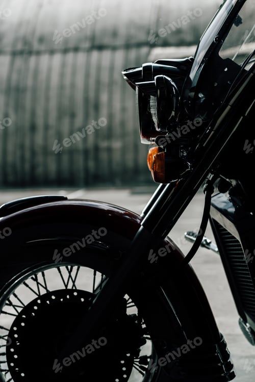 Preview: Close-up view of classic motorbike parked on pavement outdoors