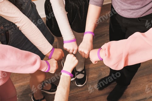 Preview: hands of girls with same bracelets, team building, cooperation, support and teamwork.