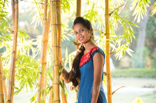 Preview: Happy smiling girl in bamboo forest.
