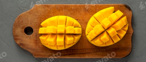 Preview: Mangoes on a rustic wooden board on a gray surface, top view. Flat lay, from above, overhead.