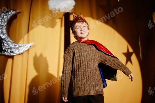 Preview: Smiling Child Performing in Costume under Stage Lights