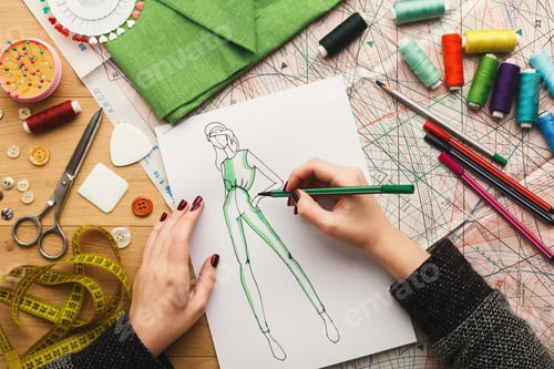 Preview: Top view on woman designer drawing clothes sketches