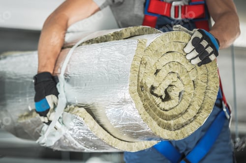 Preview: Contractor Worker with Roll of Mineral Wool Insulation