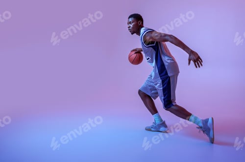 Preview: Basketball player practicing with ball in studio