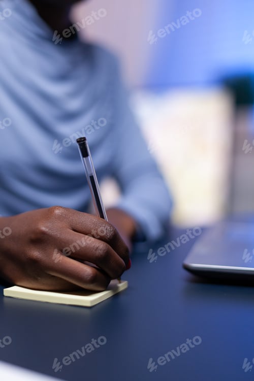 Preview: Corporate working in home office sitting at desk taking notes