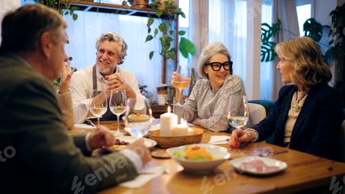 Preview: Senior friends enjoying dinner party at home