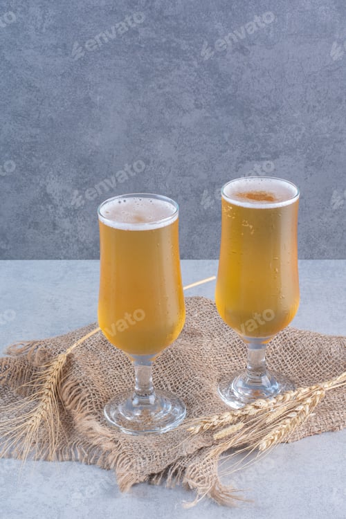 Preview: Two glasses of beer with wheats on sackcloth