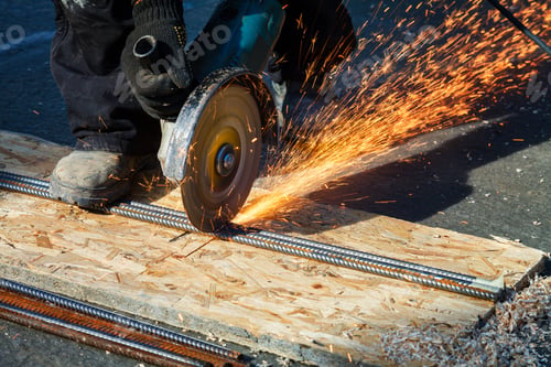 Preview: Worker cuts a metal structure with an electric flex