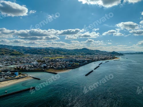 Preview: the beach is next to the water with buildings on top