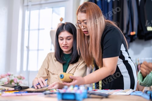 Preview: Senior fashion designer teamwork discuss teach learner final design share idea in shop lady tailor