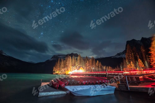 Preview: Wooden lodge and canoe parked with starry on Emerald lake at Yoho national park