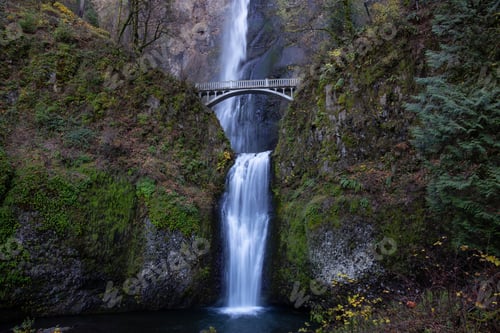 Preview: View of a bridge going over a river with Multnomah Falls in the background