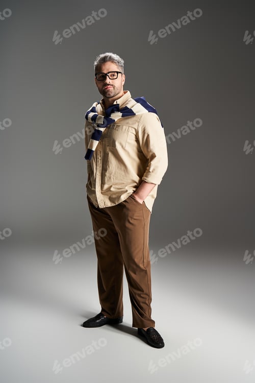 Preview: Handsome man showcasing stylish elegance in a modern studio setting