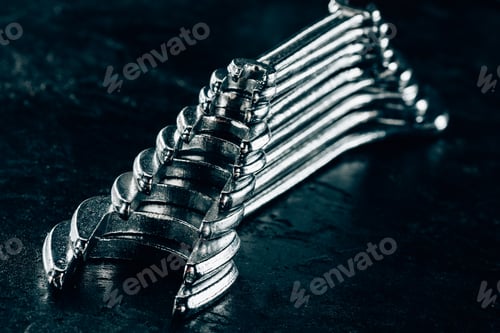 Preview: close up view of metal wrenches on dark surface