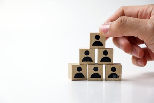 Preview: Businessman stacking wooden team blocks