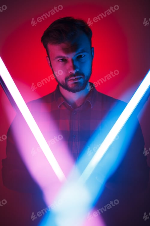Preview: Man standing behind neon lamps