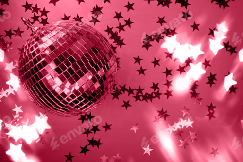 Preview: Shiny disco ball with rays on viva magenta background. Trending color of 2023.