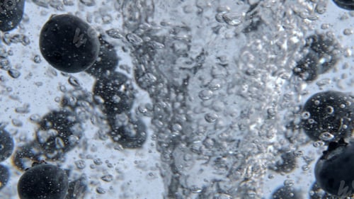 Preview: Mineral water blueberries tornado closeup. Organic berries spinning cold water