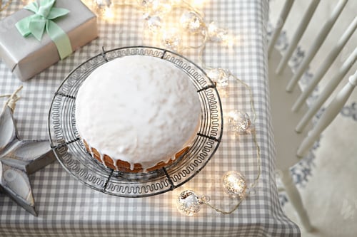 Preview: Iced cake on table with decorative lights
