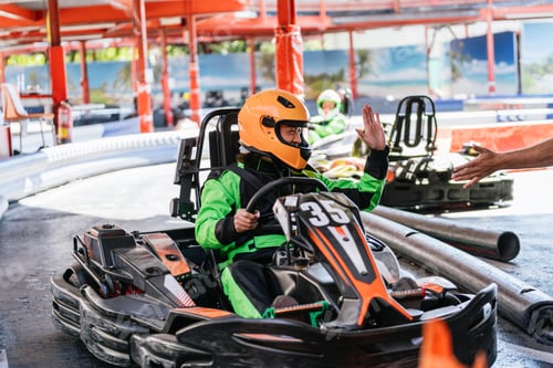 Preview: Go kart racer high fiving on track, starting race