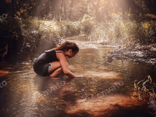 Preview: Girl playing in creek on a summers day